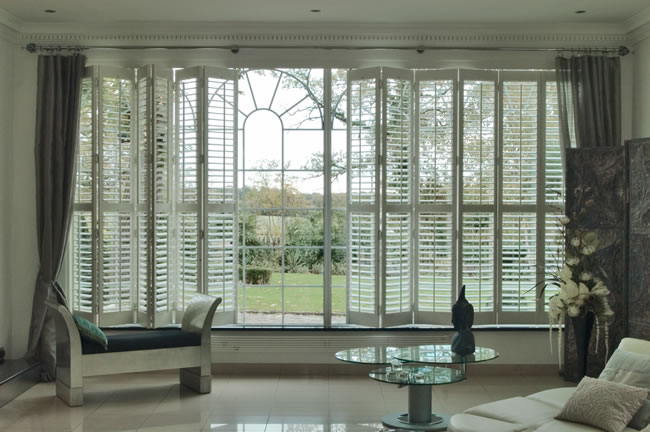 Plantation shutters shown installed in a living room.